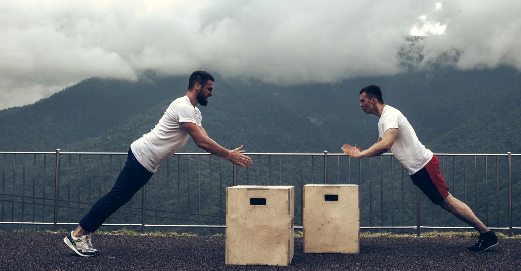 Two guys doing plyo push-ups.